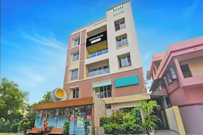 A multi-story building with a sign indicating it is a company-serviced townhouse.