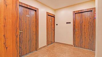A hallway with three wooden doors, each marked with a number.