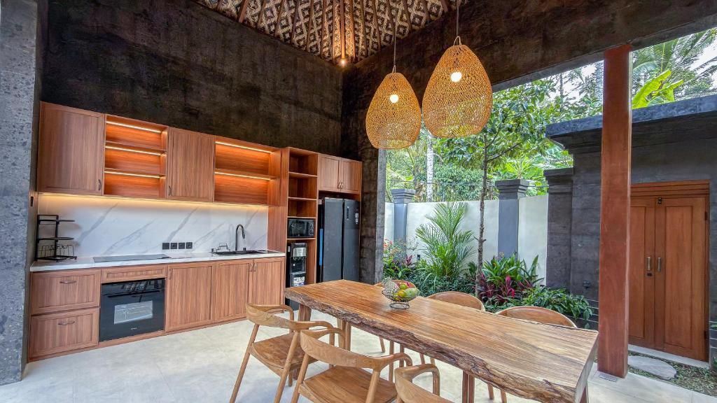 A modern kitchen with wooden cabinets, a built-in oven, and a dining area with a wooden table and chairs.