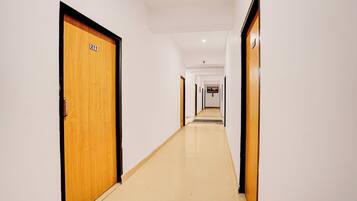A corridor with wooden doors, each marked with a number.