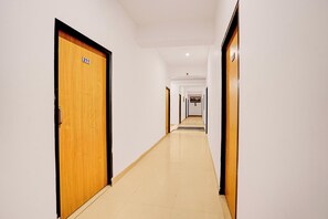 A corridor with wooden doors, each marked with a number.
