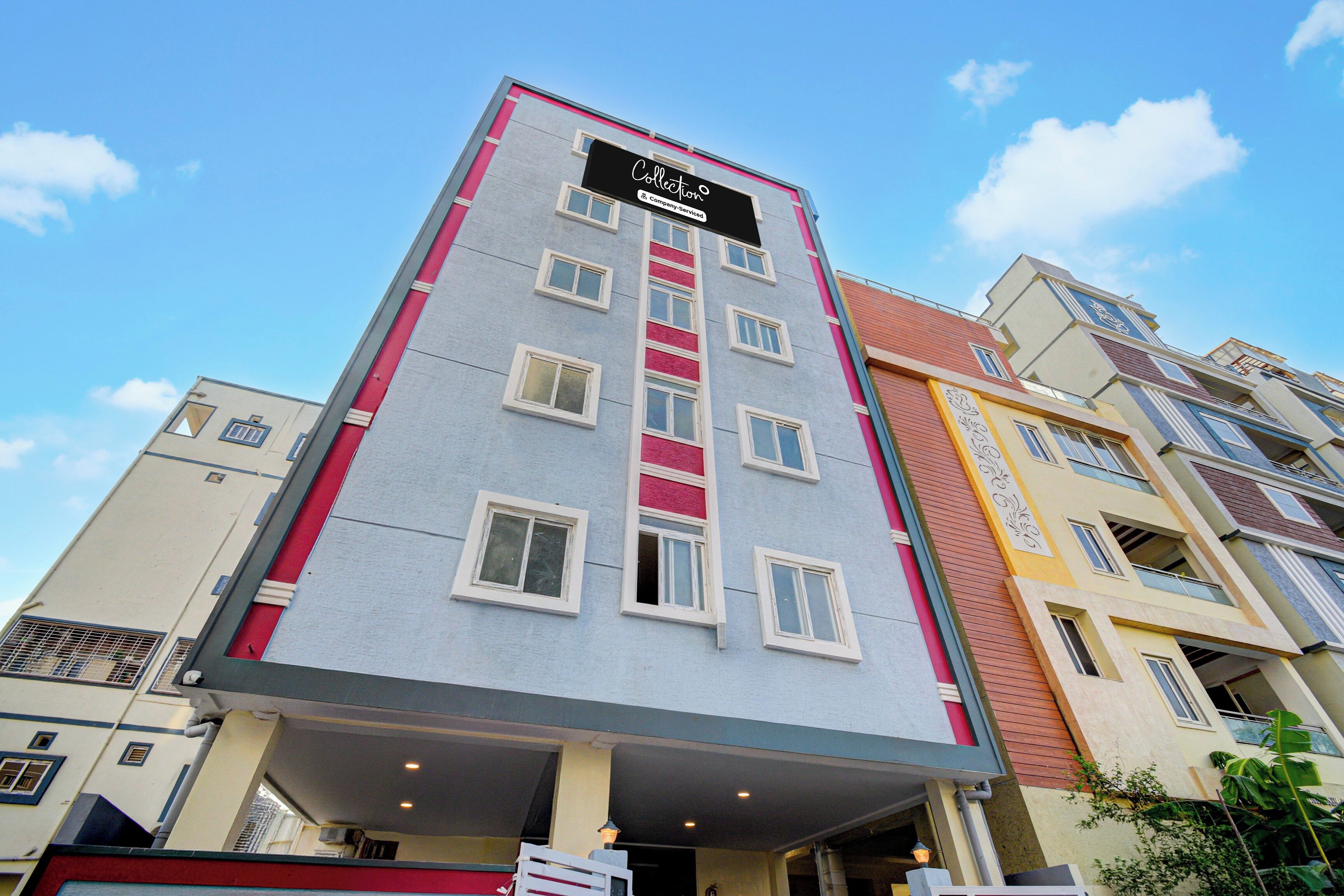 A multi-story hotel building with a prominent sign at the top.