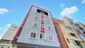 A multi-story hotel building with a prominent sign at the top.