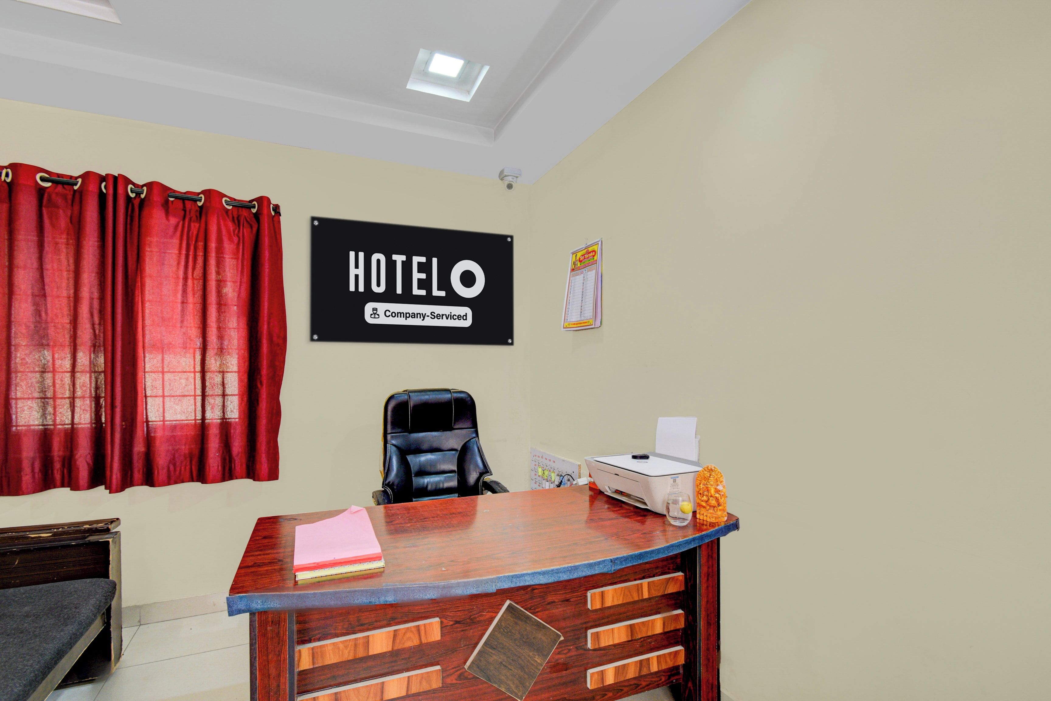 A hotel reception desk with a sign that reads 'HOTEL Company Serviced'.
