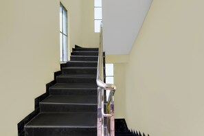 A staircase with a handrail, leading upwards.