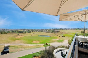 A golf course with a clubhouse and a view of a residential area in the distance. - Tee Off & Unwind at Jackal Creek by ctha (Roodepoort)