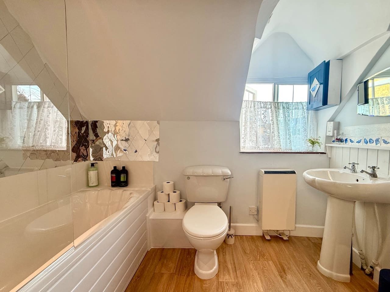A bathroom with a bathtub, toilet, and sink.