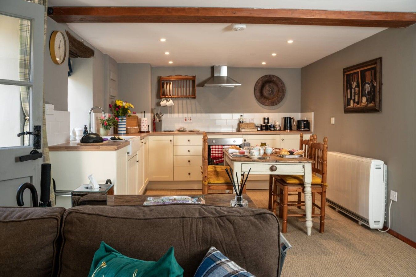 A cozy kitchen with a dining area, wooden furniture, and a radiator.