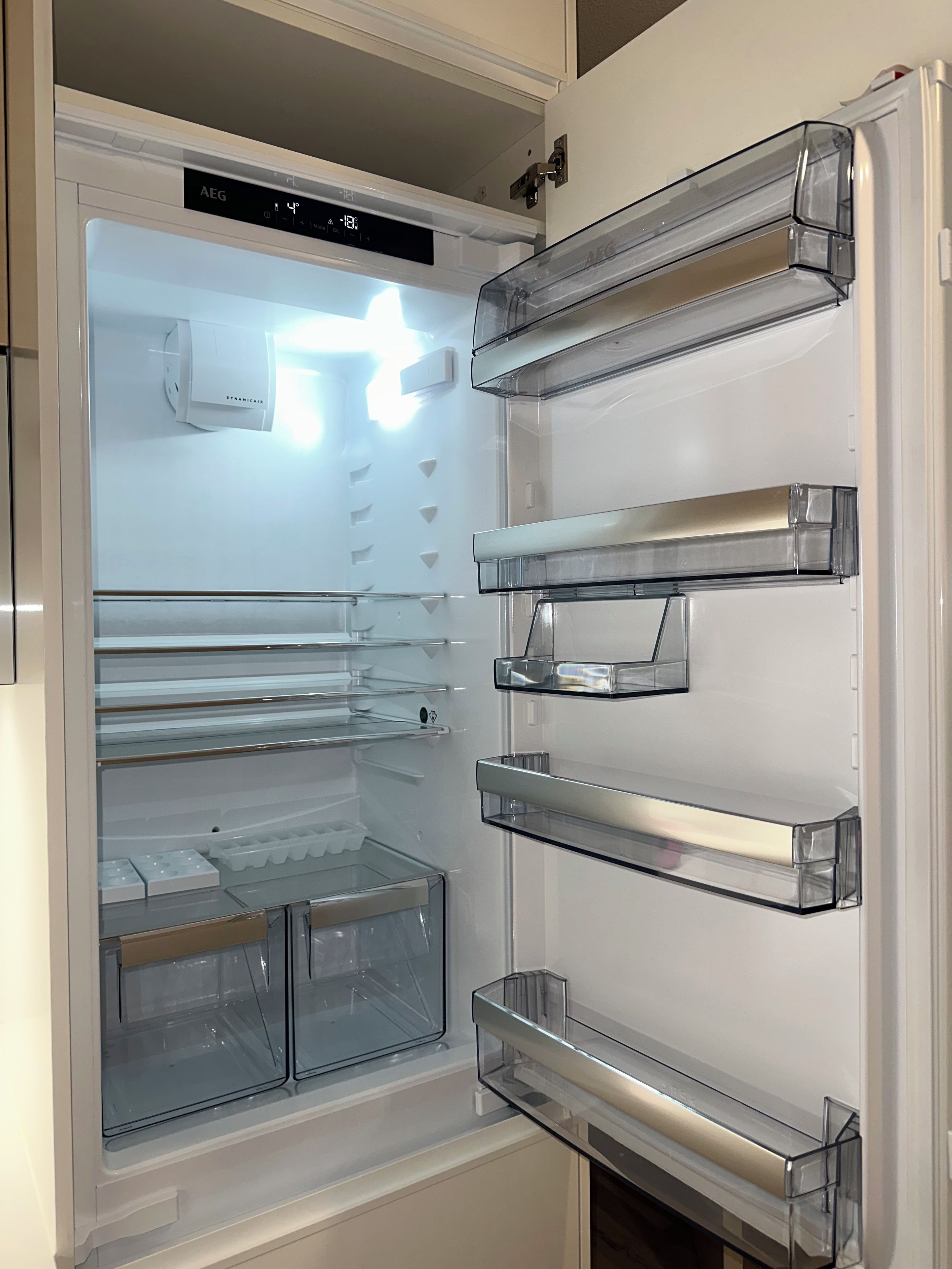 An open refrigerator with multiple shelves and compartments.