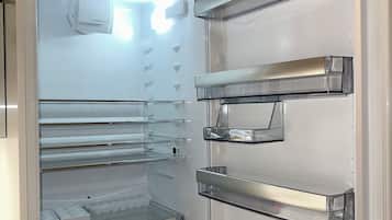 An open refrigerator with multiple shelves and compartments.
