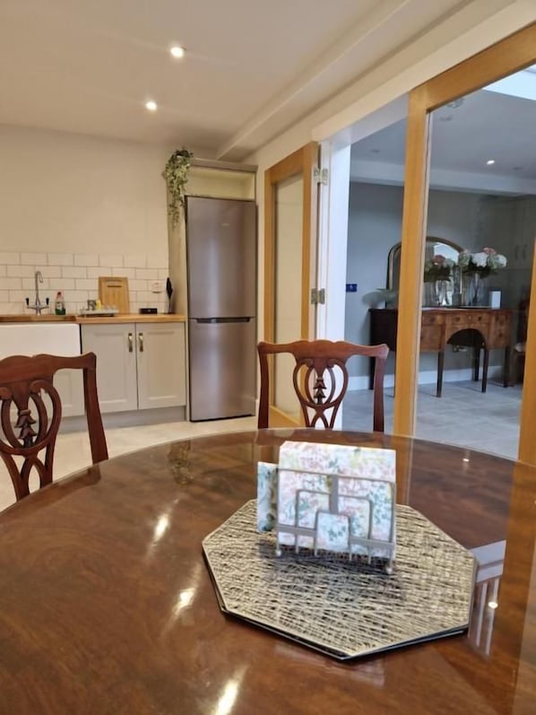 A dining area with a round table, chairs, and a decorative centerpiece.