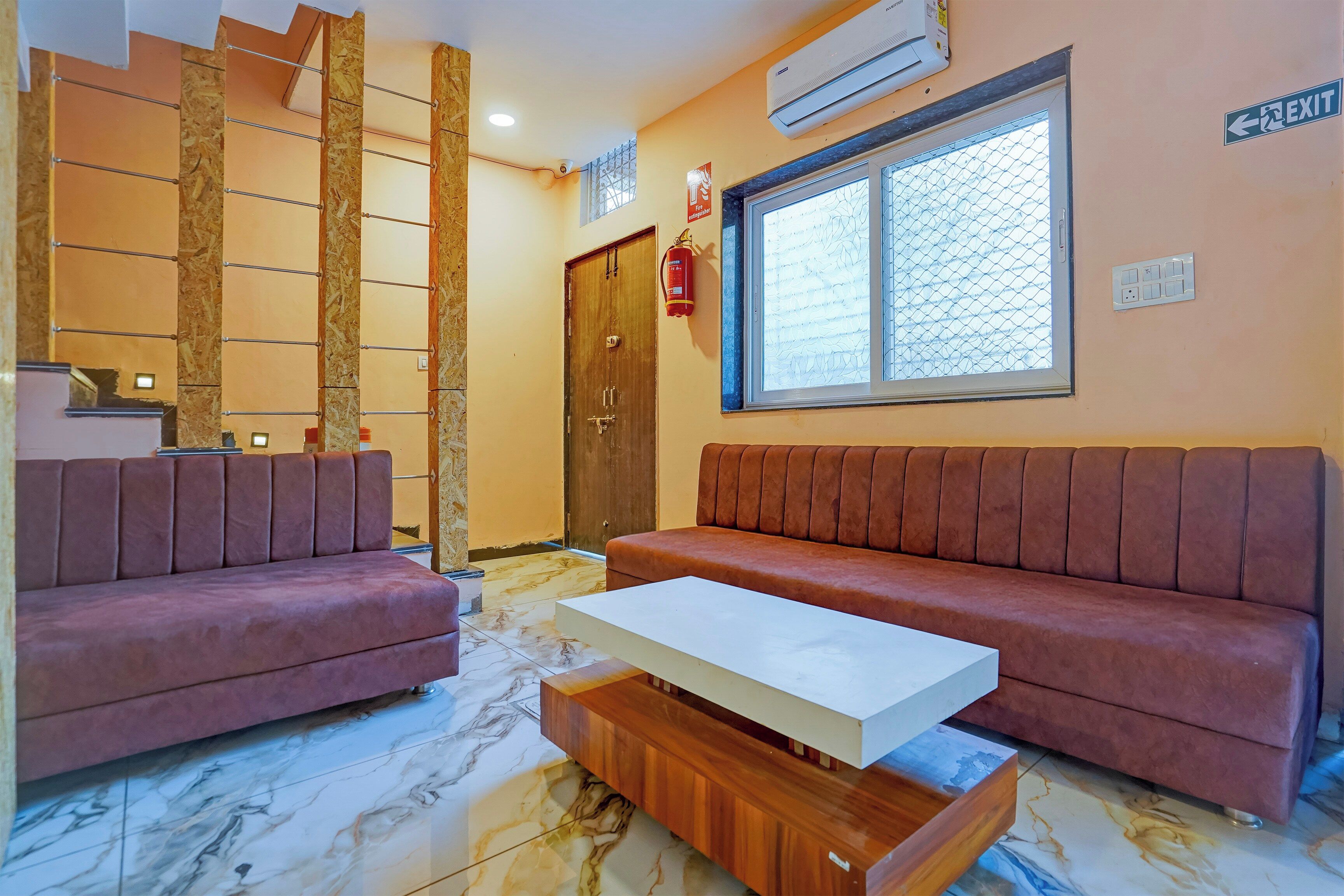 A modern living room with two sofas, a coffee table, and a large window.