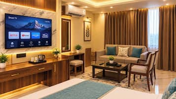 A modern living room with a flat-screen TV, sofa, coffee table, and a ceiling fan.