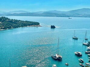A coastal marina with boats docked and a clear view of the surrounding landscape.