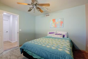 A bedroom with a bed, a ceiling fan, a door, and a wall-mounted air vent. - Near Hiking! Mtn-view Poolside Retreat in Phoenix (Phoenix)