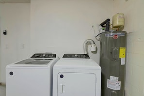 A laundry area with two Whirlpool washers and a Rheem water heater. - Right on Canal! Sleek Home Near Gulf Coast Fun (Hudson)