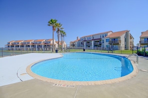 A swimming pool with a '5 FT NO DIVING' sign, surrounded by a fence, with residential buildings in the background. - Aransas Bayfront, Fishing Pier and Boat Ramp (Rockport)