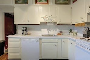A kitchen with white cabinets, a coffee maker, a dishwasher, and a stove. - Rustic Cabin-stunning View-cov Porch
delaware Gem! (Damascus)
