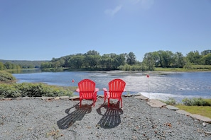 Two red chairs facing a river with a clear sky. - Rustic Cabin-stunning View-cov Porch
delaware Gem! (Damascus)