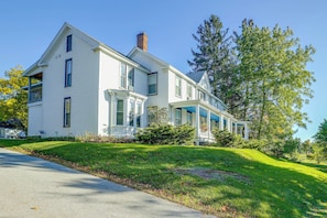 A large, two-story house with a prominent front porch and a chimney. - Saint Albans Home: Walk to Main Street! (St. Albans)