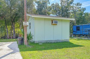 A small, single-story building labeled 'Boat House' with a small window and an air conditioning unit.