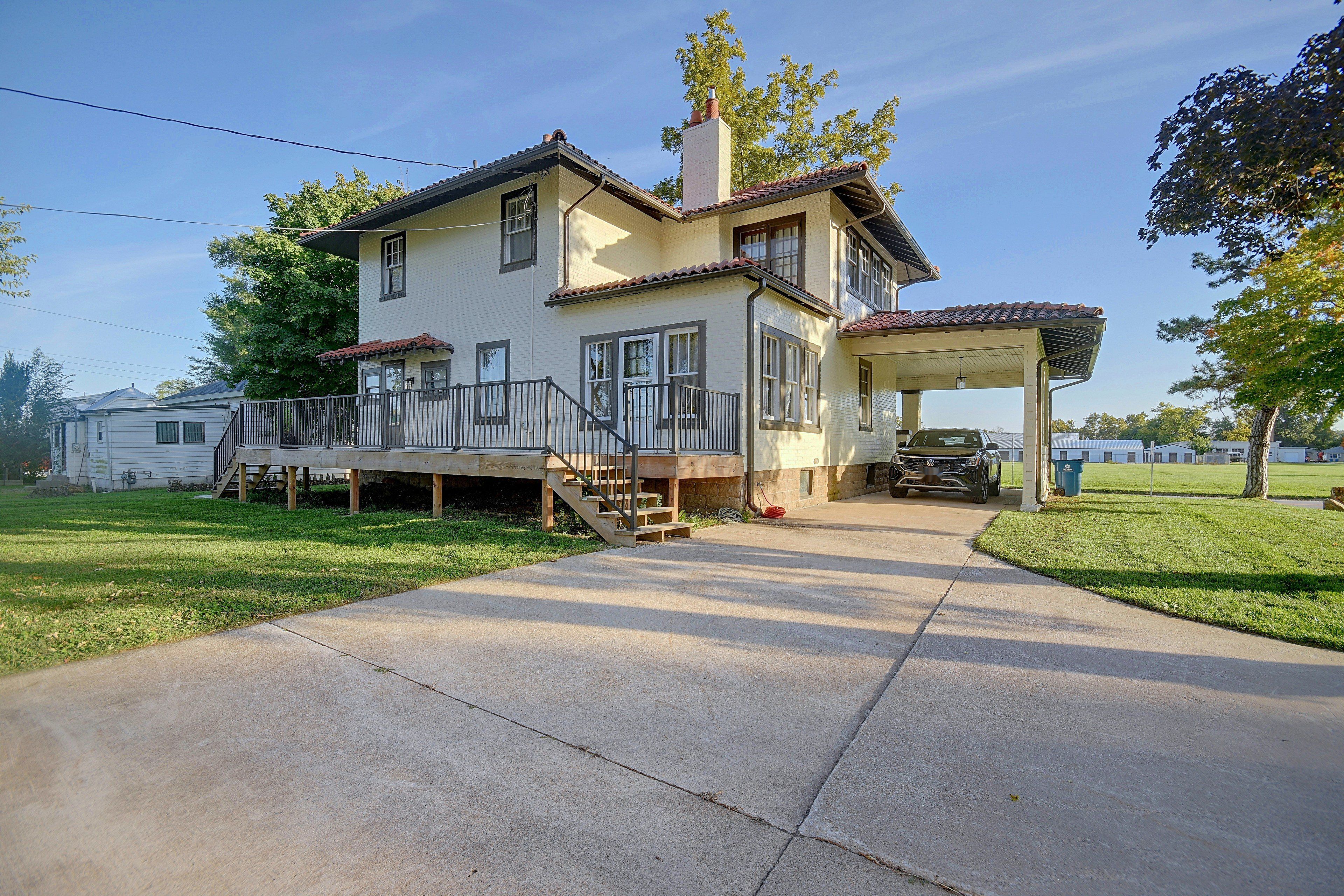 A two-story house with a covered porch and a garage.