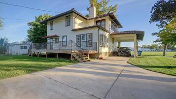 A two-story house with a covered porch and a garage.