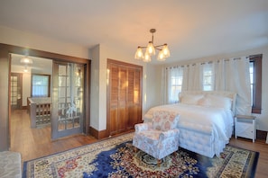 A bedroom with a large bed, a chair, a wardrobe, and a mirror. - 1 Mi to Culver-stockton College: Home w/ Yard (Canton)