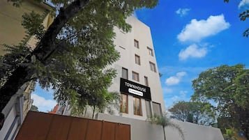 A multi-story building with a sign indicating it is a company-serviced townhouse.