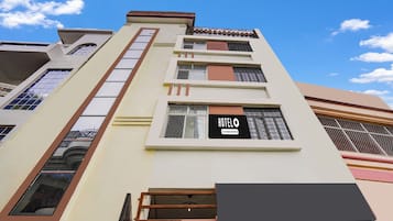 A multi-story building with a prominent 'HOTEL' sign on the facade, indicating a commercial establishment.