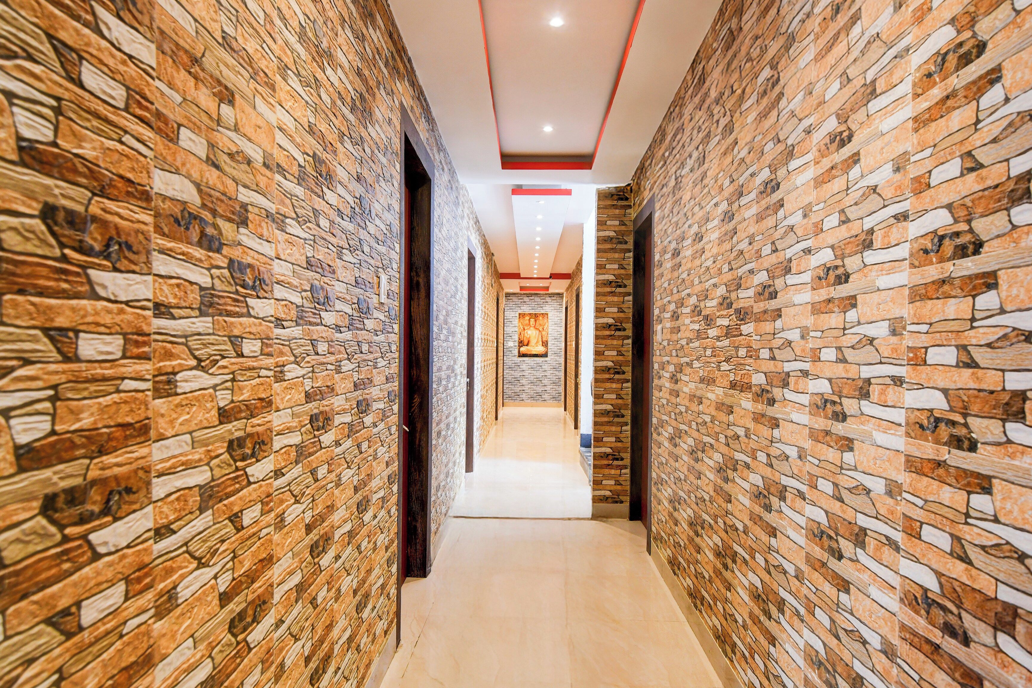 A corridor with textured stone walls and a central walkway.