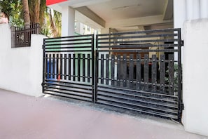A gated entrance with a metal gate and steps leading up to a building. - OYO 834317 Love Point (Kolkata)