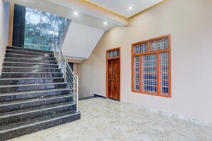 A staircase with a handrail leading to a landing.