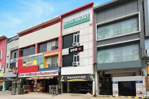 Un edificio de varios pisos con un hotel llamado 'Hotel Galaxy' en el segundo nivel.