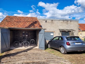 Un garage con un'auto e biciclette al suo interno.