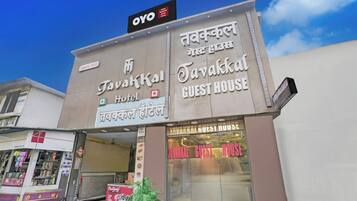 A building with signs for 'Tavakkal Hotel' and 'Tavakkal Guest House' in both English and another language.