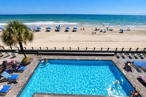 A pool area with a view of the beach and ocean. - Oceanfront 2bed/2bath-Water's Edge Resort-211 Indoor/Outdoor Pool & Hot Tub (Murrells Inlet)