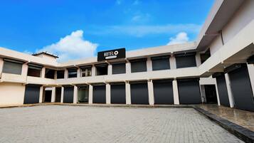 A hotel with a sign reading 'HOTEL' and multiple closed shutters on the ground floor.