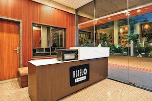 A hotel reception desk with a sign indicating it is serviced by OYO. - Hotel O Khatu Shyam Temple (Danta Ramgarh)