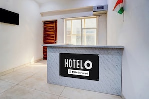 A hotel reception desk with a sign indicating it is 70% serviced. - Hotel O Sector 49 Noida (Noida)