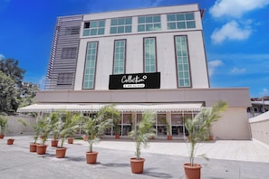 A modern building with a sign reading 'Collection' and 'Oyo-serviced'.