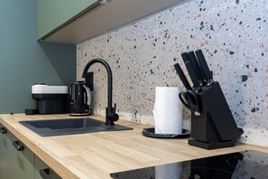 A kitchen with a black coffee maker, a sink, and a knife block. - Modern 1 BR Flat in Liverpool City Centre (Liverpool)