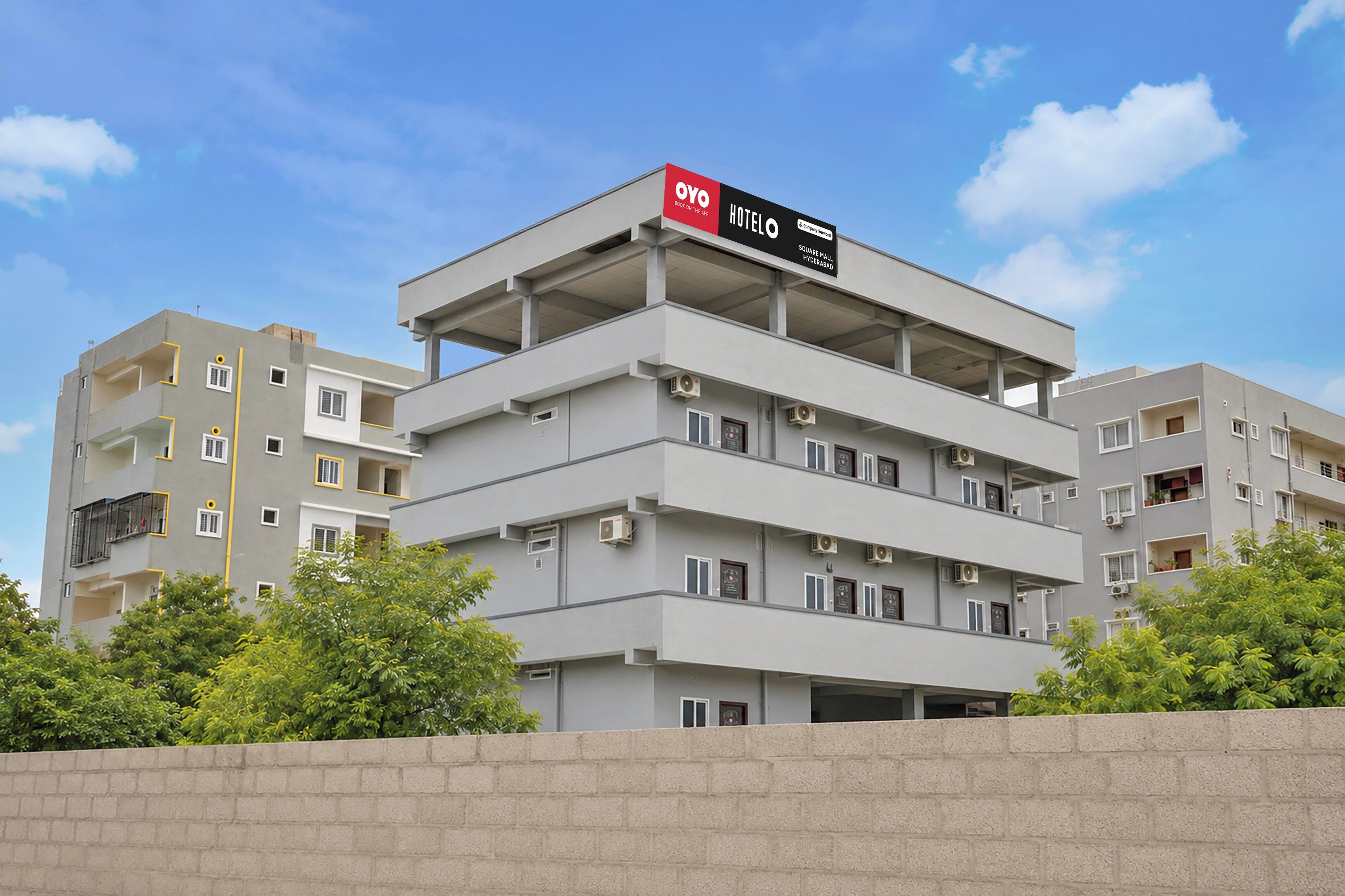 A multi-story hotel building with a prominent sign for OYO Hotel.