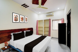 A bedroom with a bed, a nightstand, a ceiling fan, an air conditioning unit, a wardrobe, and a window with curtains. - Super Hotel O Square Mall Hyderabad (Hyderabad)
