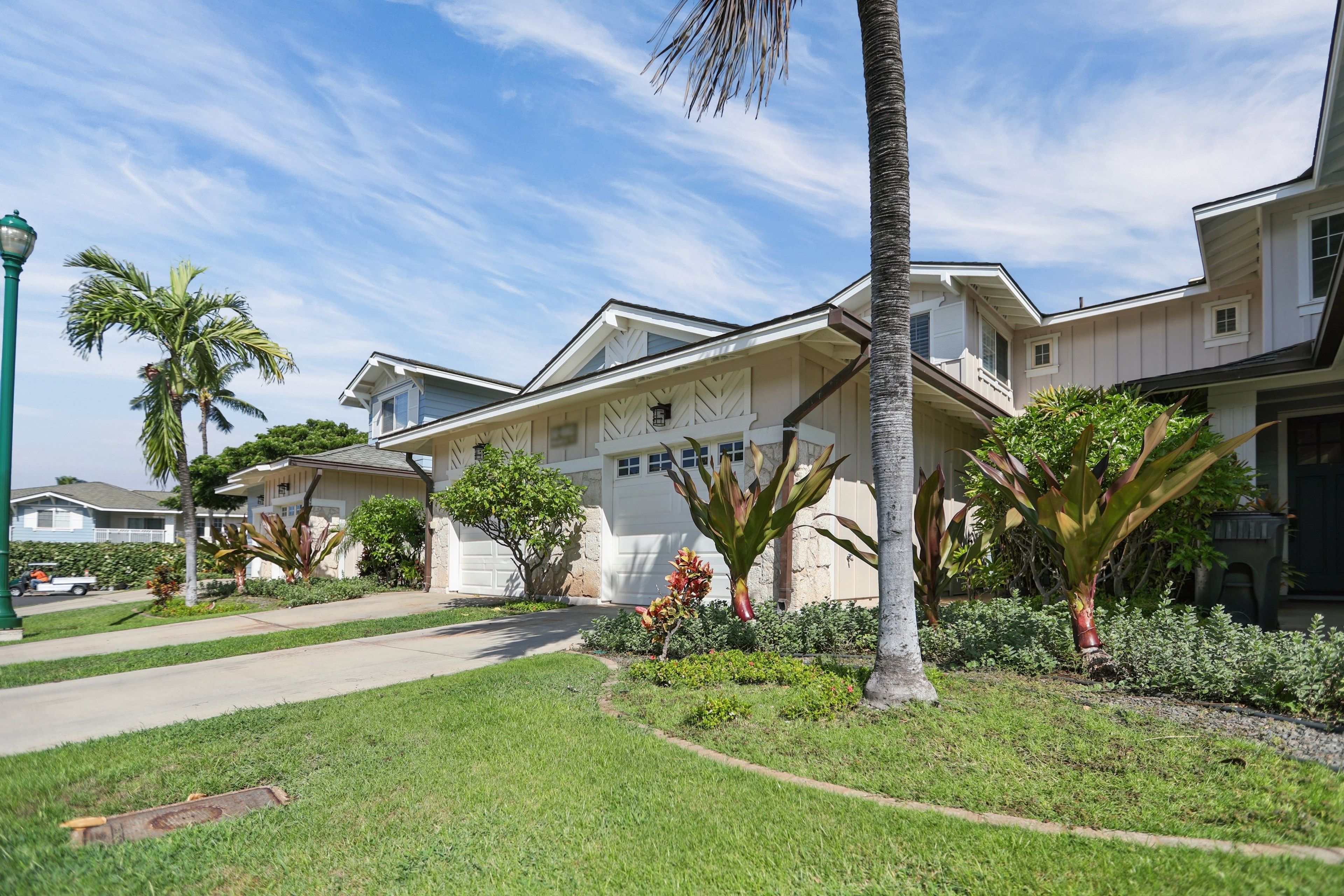 A residential property with a garage, a driveway, and a well-maintained lawn.