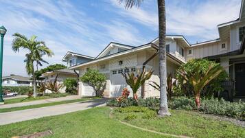 A residential property with a garage, a driveway, and a well-maintained lawn.