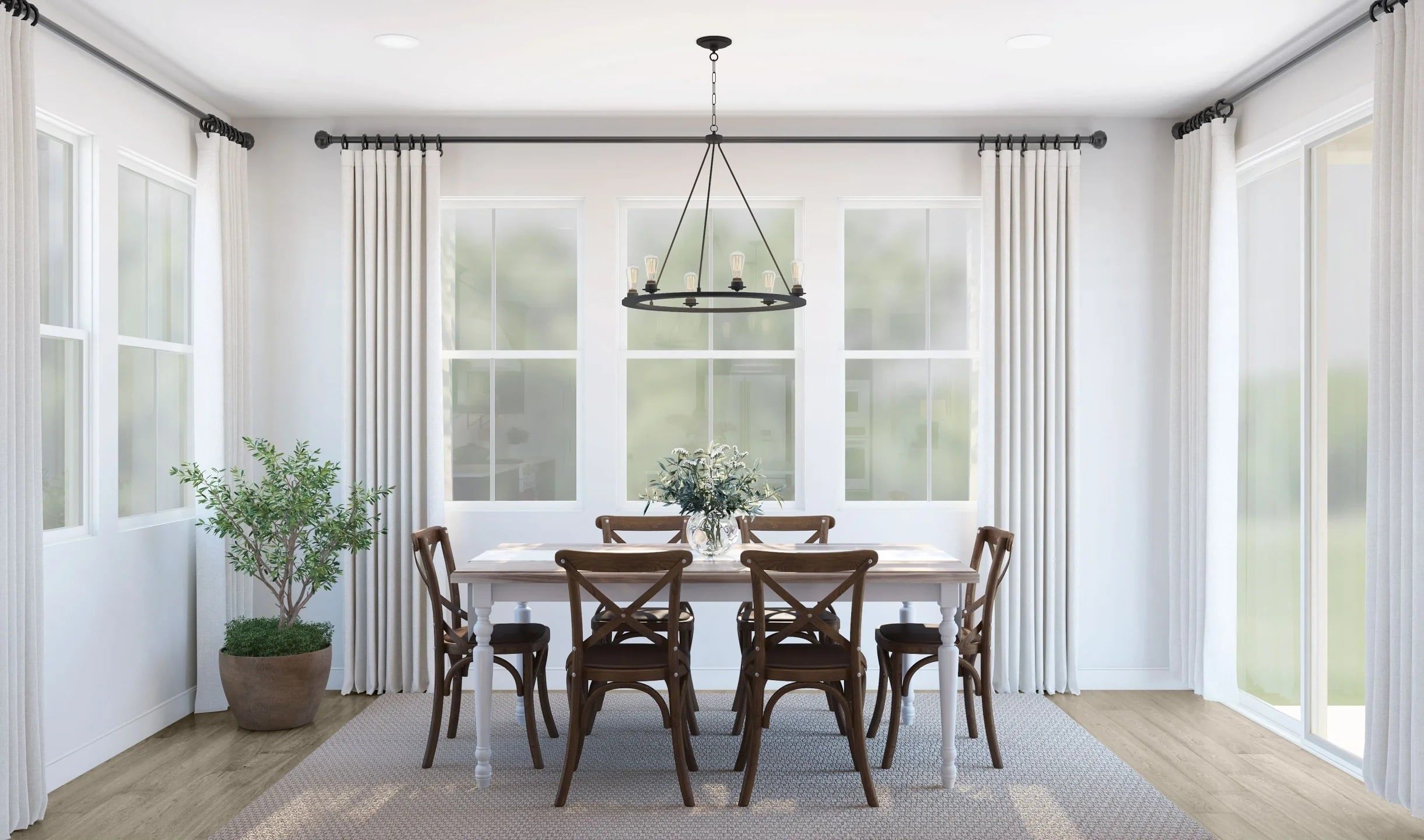 A dining room with a large window, a chandelier, and a potted plant.
