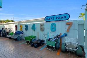 A cart parking area with numbered carts and a sign indicating 'Cart Park'. - Siesta Sunset Royale #3 1 Bedroom Apts (Siesta Key)