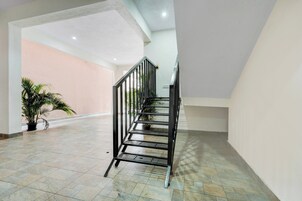Una escalera con barandilla de metal que conduce a un piso superior.
