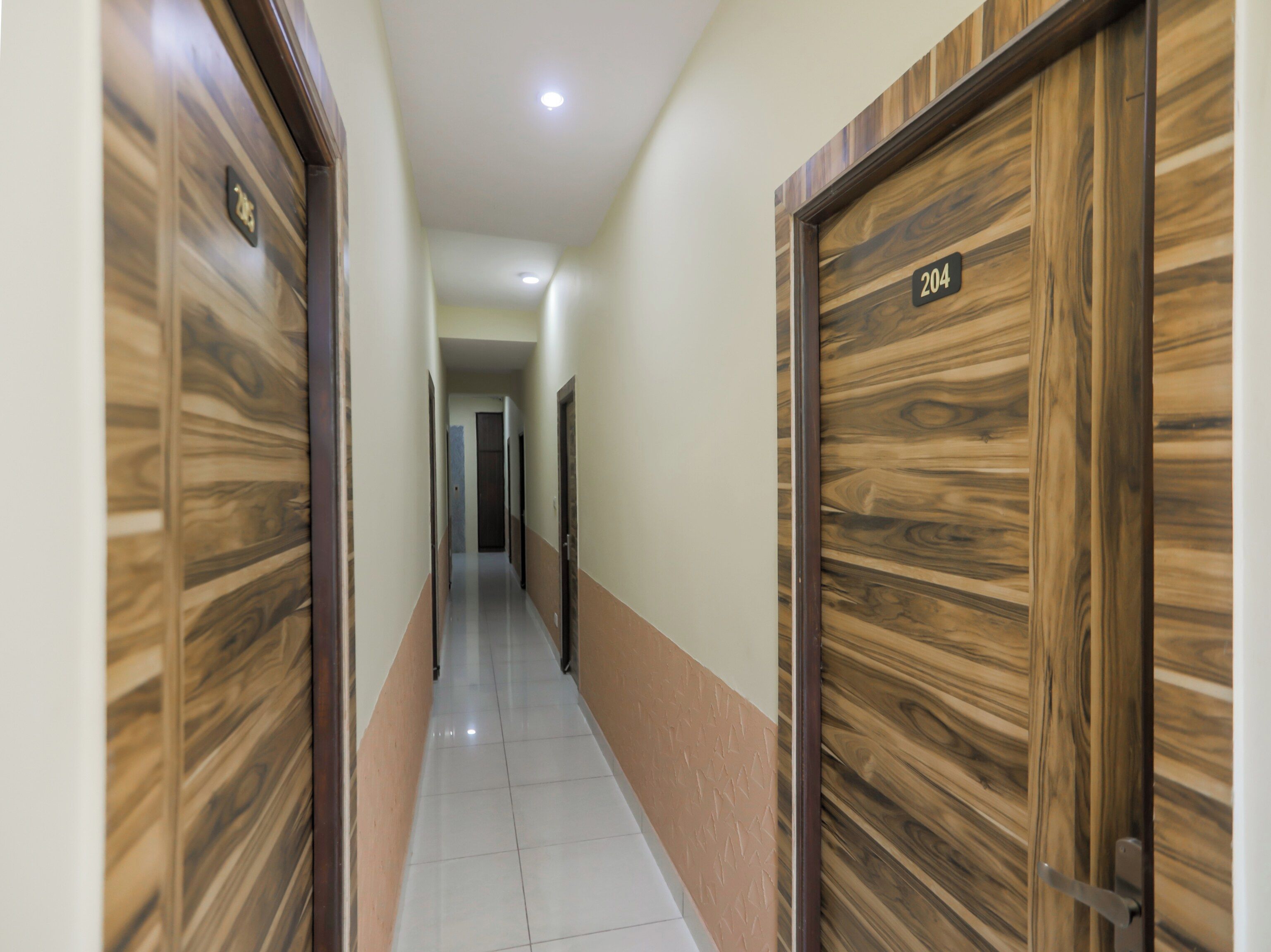 A hallway with wooden doors, numbered 204 and 205, leading to rooms.